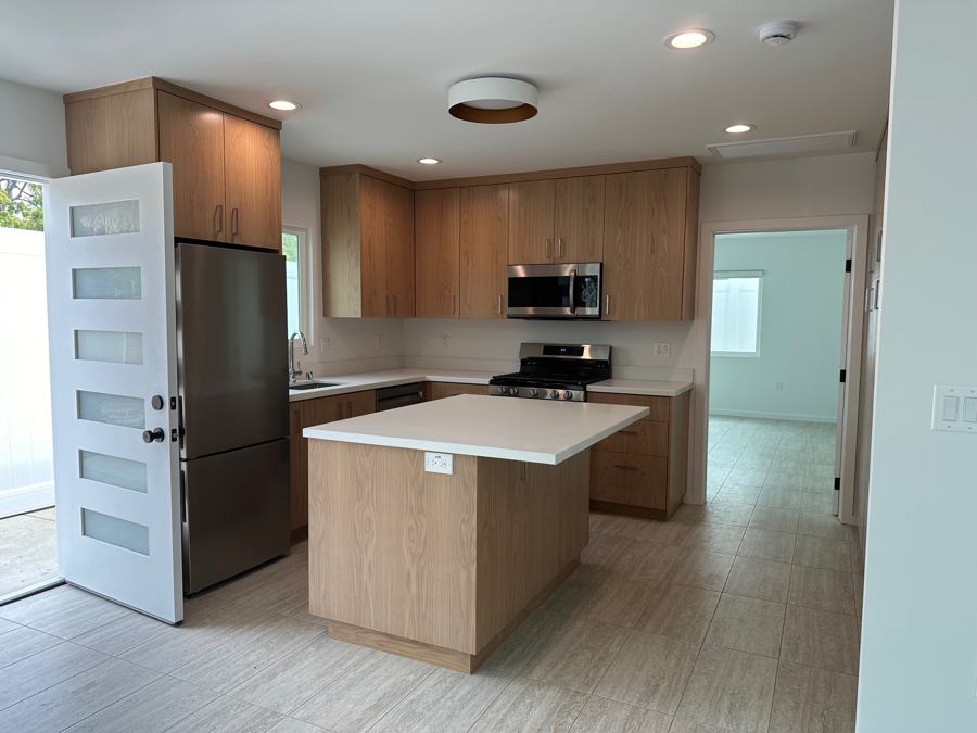 Burbank ADU kitchen with natural wood cabinetry and a central island
