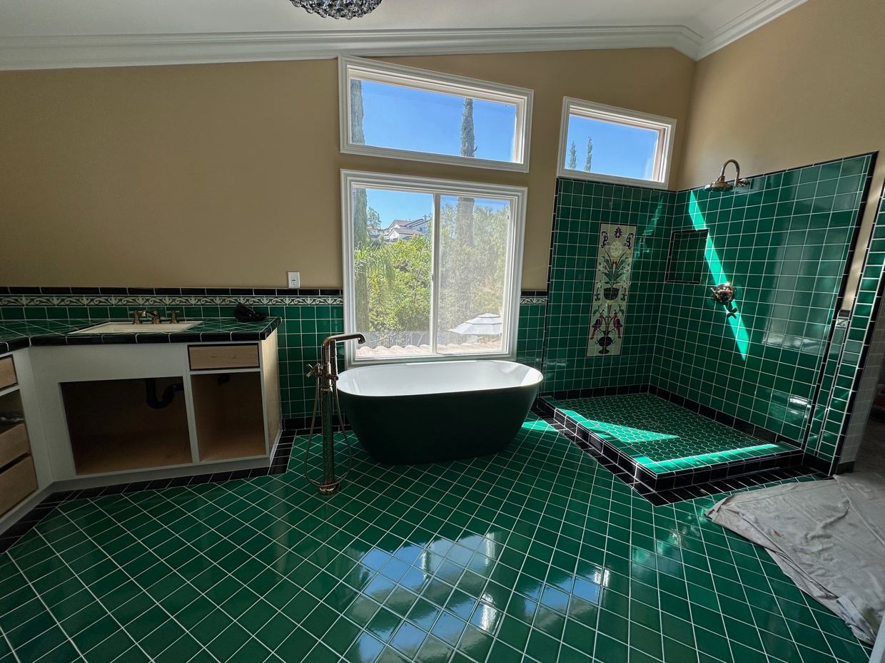 Castaic Green Room: An expressive green-tile bath renovation with a freestanding soaking tub.